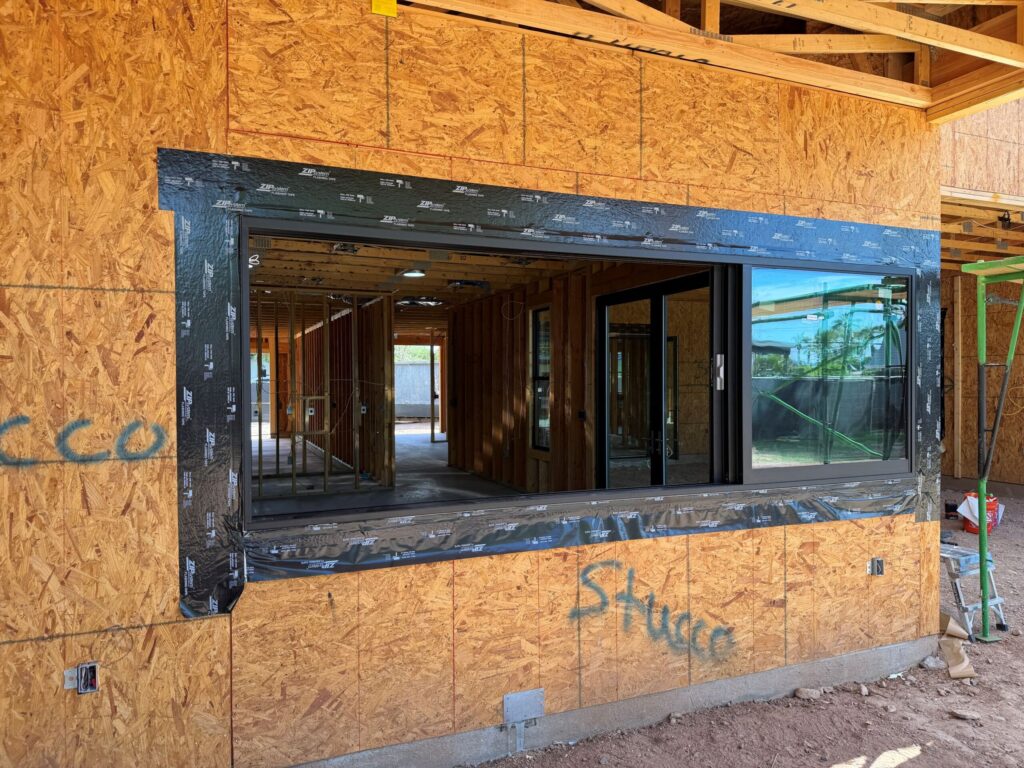 Ambassador aluminum multi-slide window with its panels slid open and stacked at one side